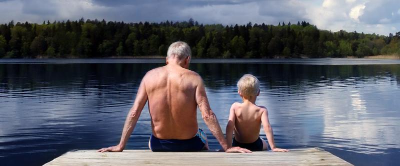 Grandfather and Grandson sitting on a footbridge